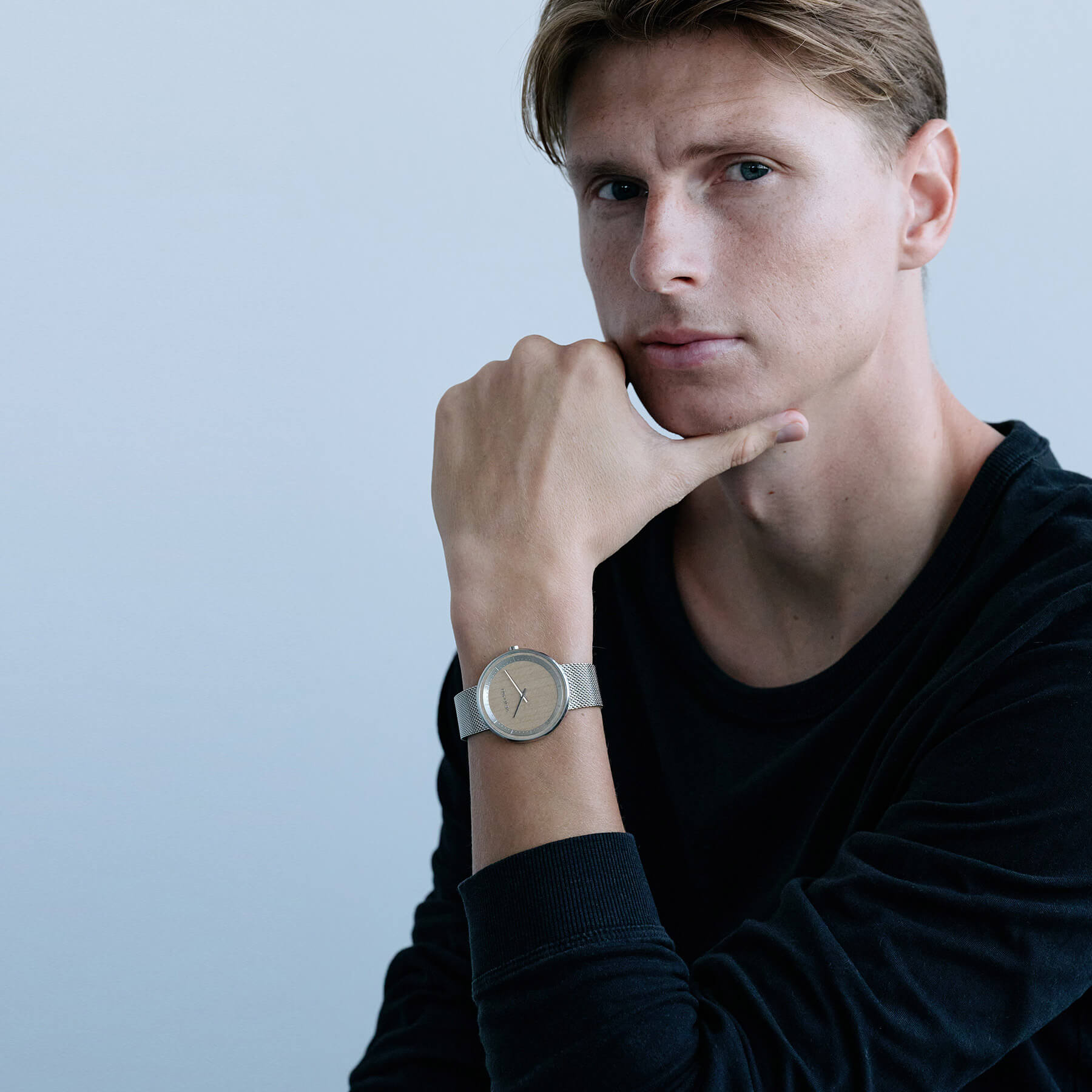 Kasper Junker wearing a simple wooden watch with steel casing and steel mesh band