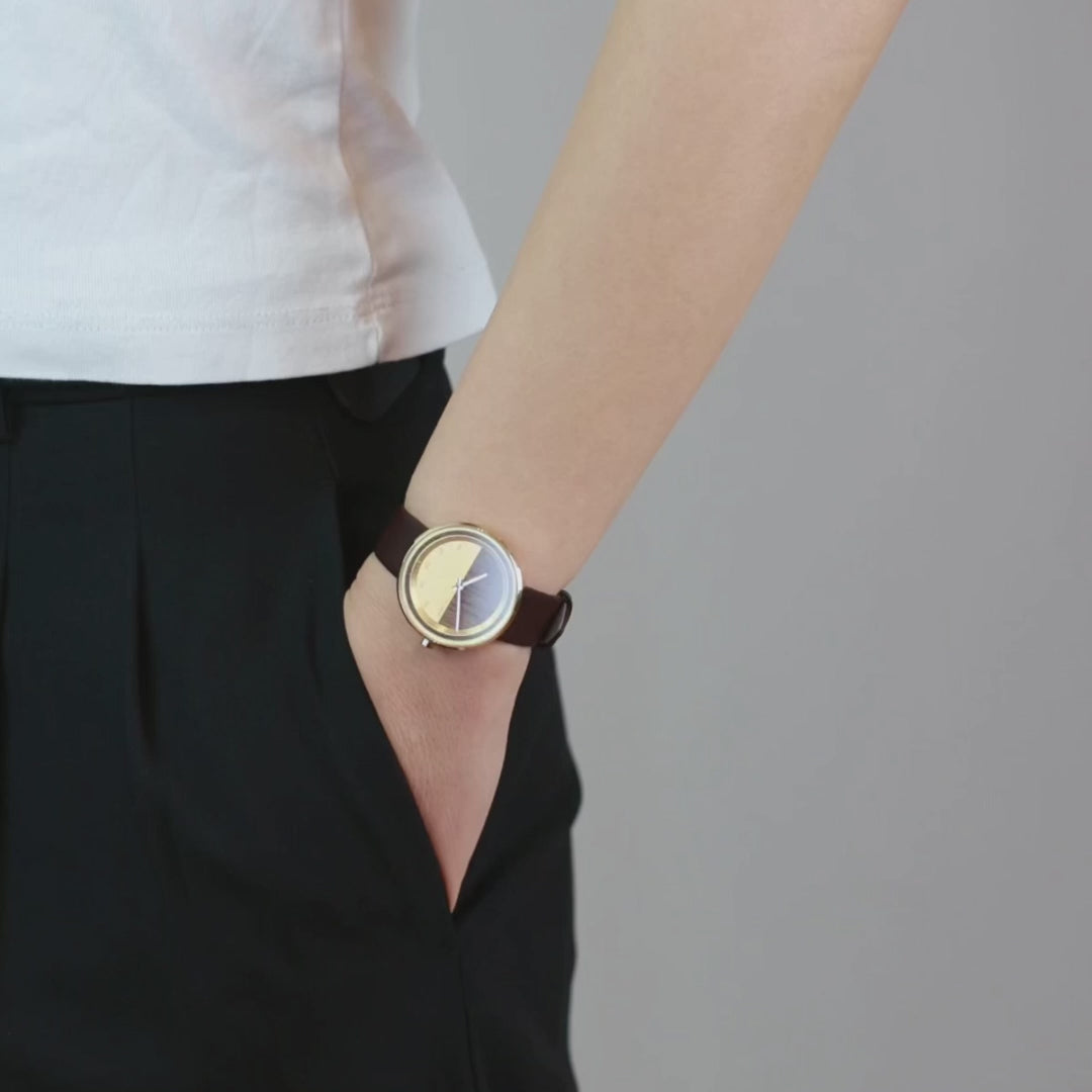 Petite gold women's watch being worn and showcased
