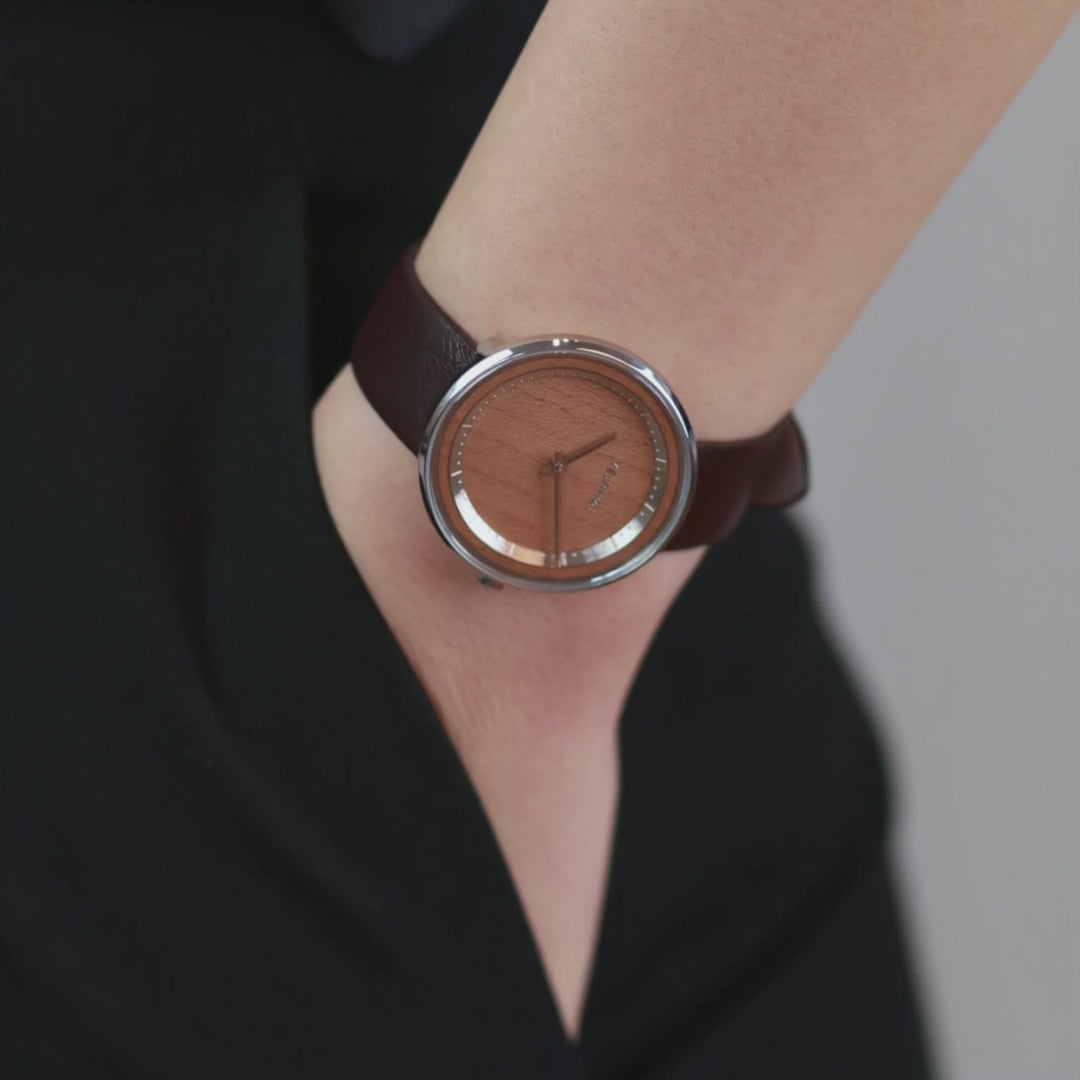 Woman wearing simple watch and showcasing