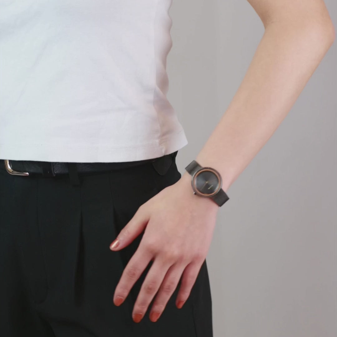 Woman showcasing black, stylish watch