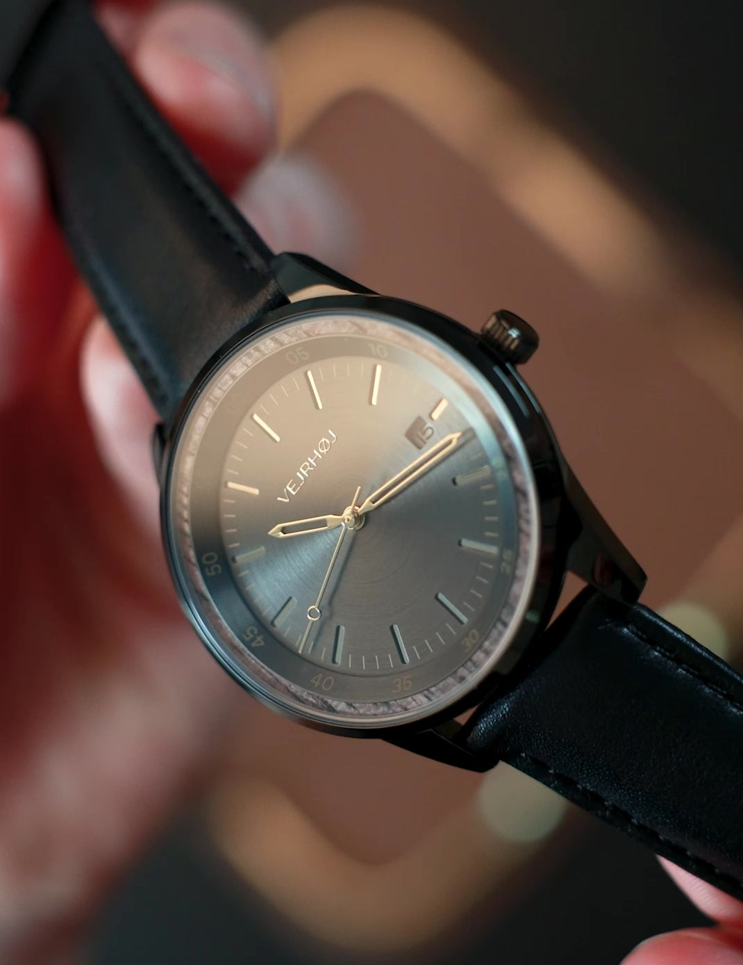 The black automatic wrist watch from VEJRHOJ being presented and seen from all sides