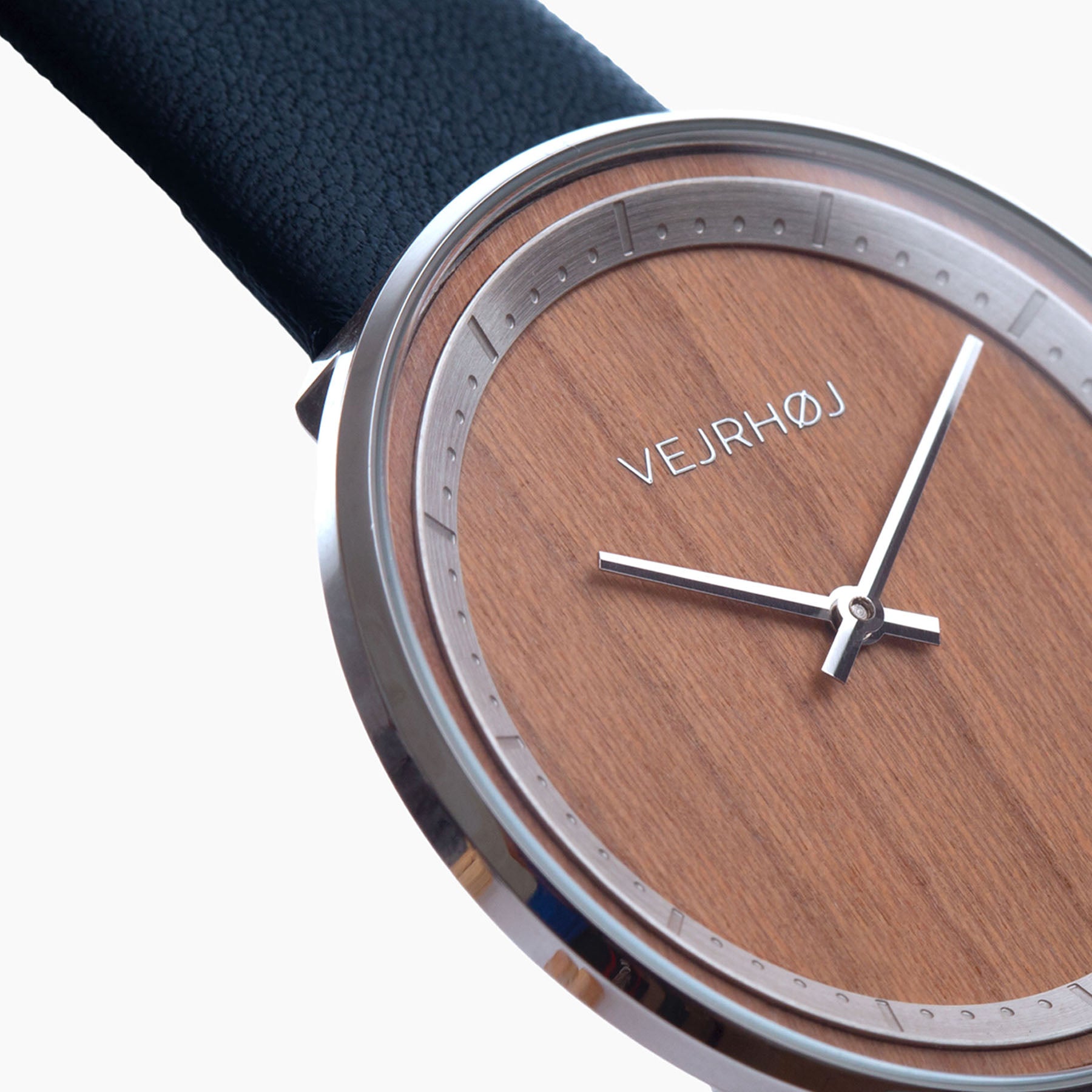 Closeup of wooden watch with silver hands and steel casing