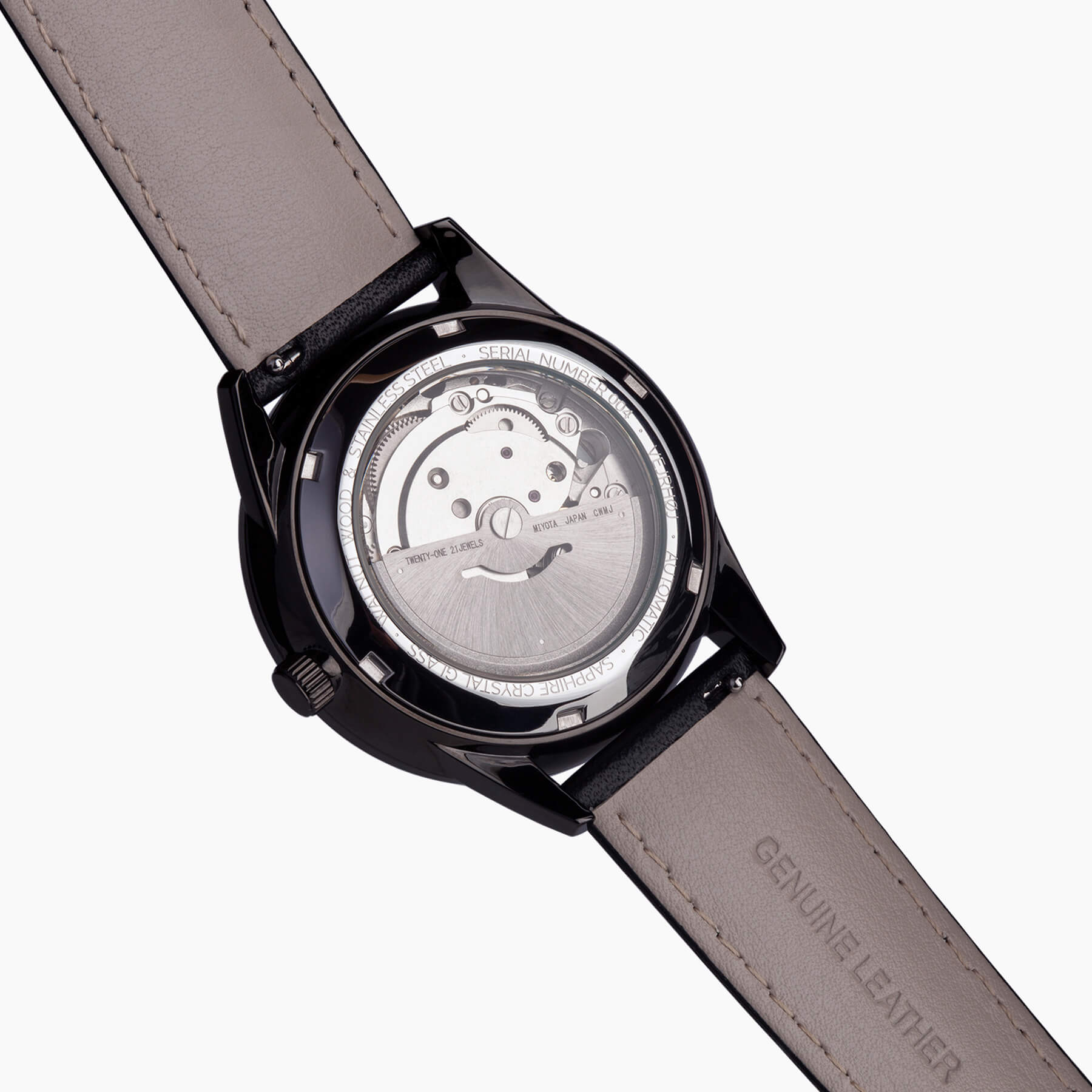 the backside of a black automatic watch showing a inner mechanism of a watch
