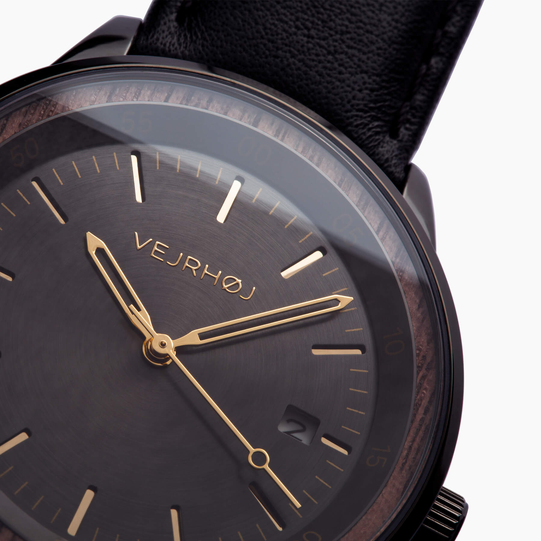 closeup of a black automatic watch with black straps