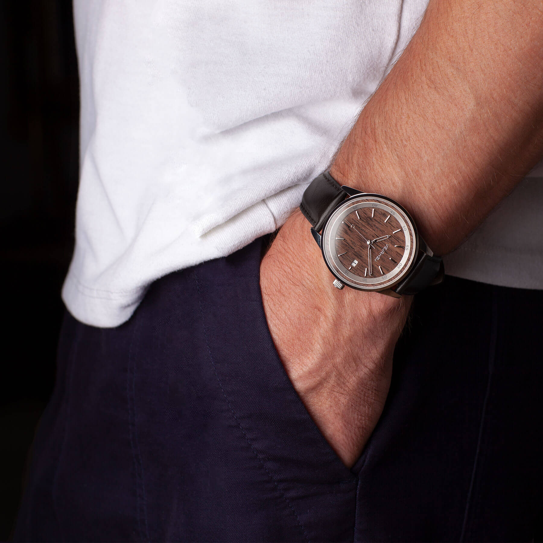 brown automatic watch with black straps and silver hands being worn