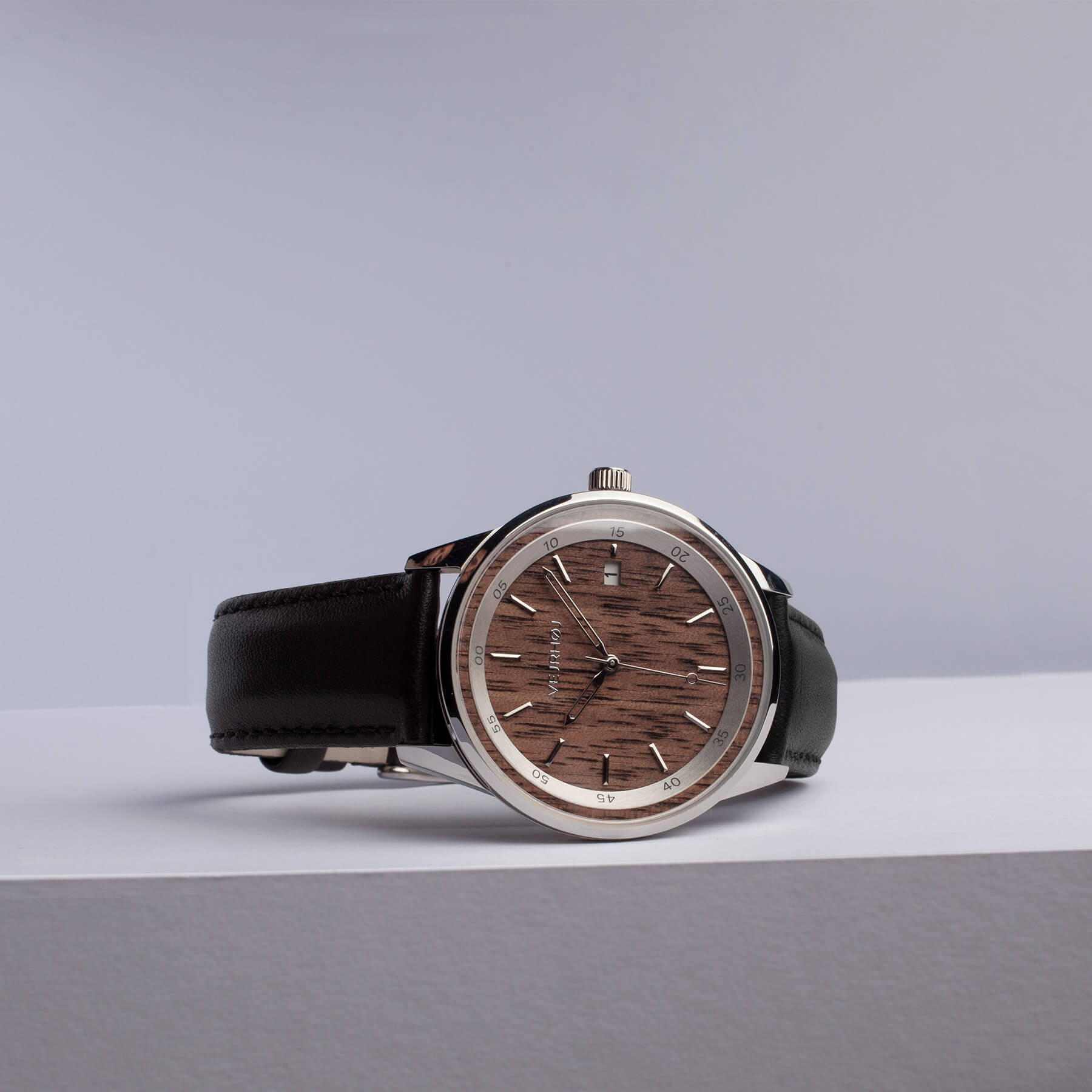 brown automatic wrist watch with black straps and silver hands and hour markings