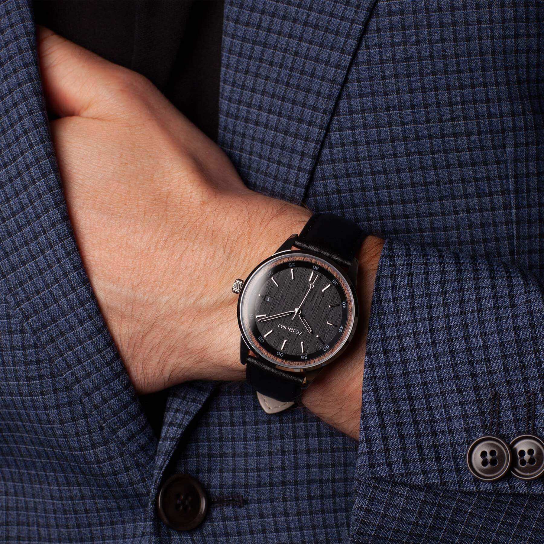 black stained walnut wood automatic watch with silver hands paired with blue suit