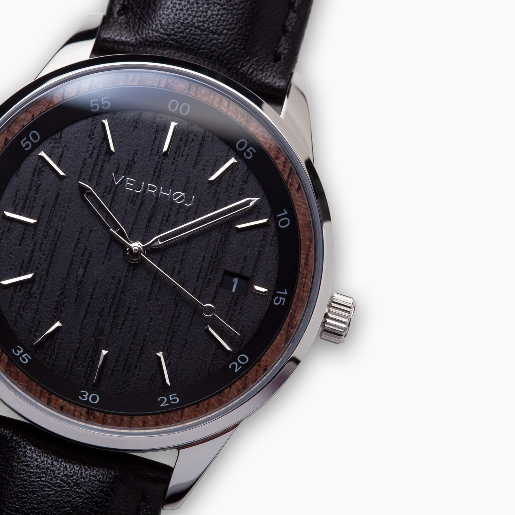 closeup of black automatic wrist watch clearly displaying the VEJRHØJ logo in silver color