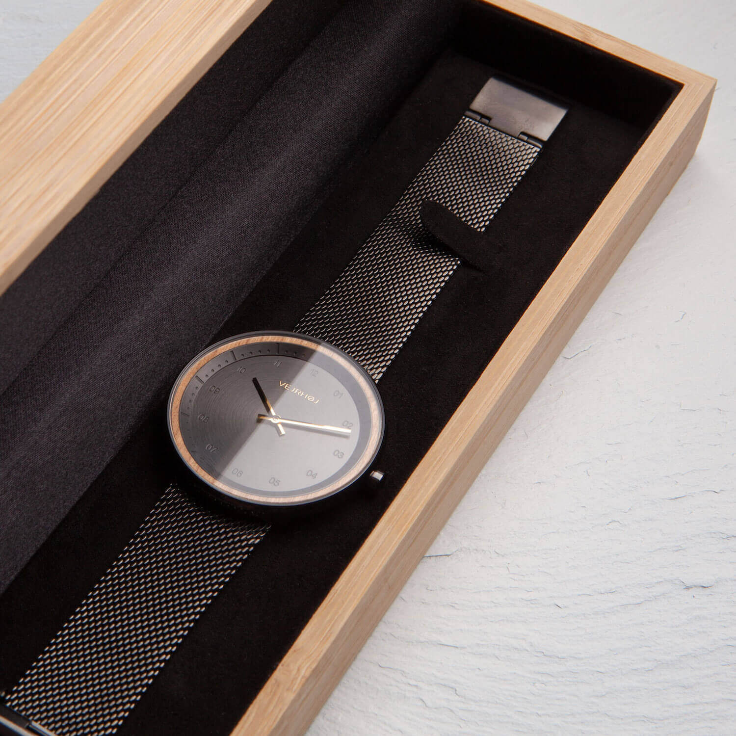 black simple watch in wooden box