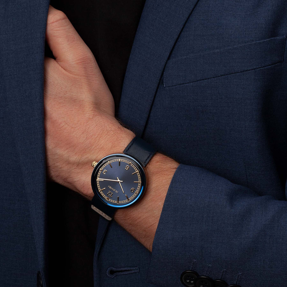Blue and gold minimalistic watch with numbers on hand from VEJRHØJ