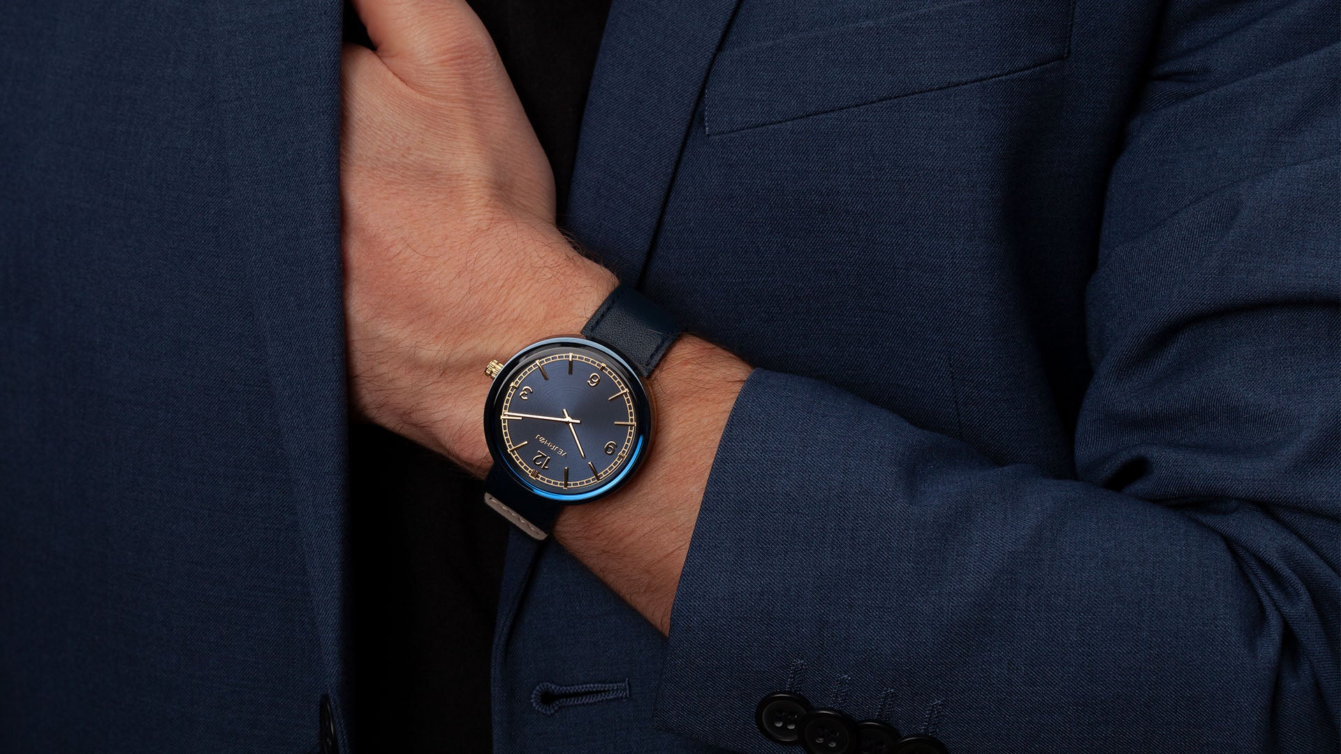 Blue and gold minimalistic watch with numbers on hand from VEJRHØJ