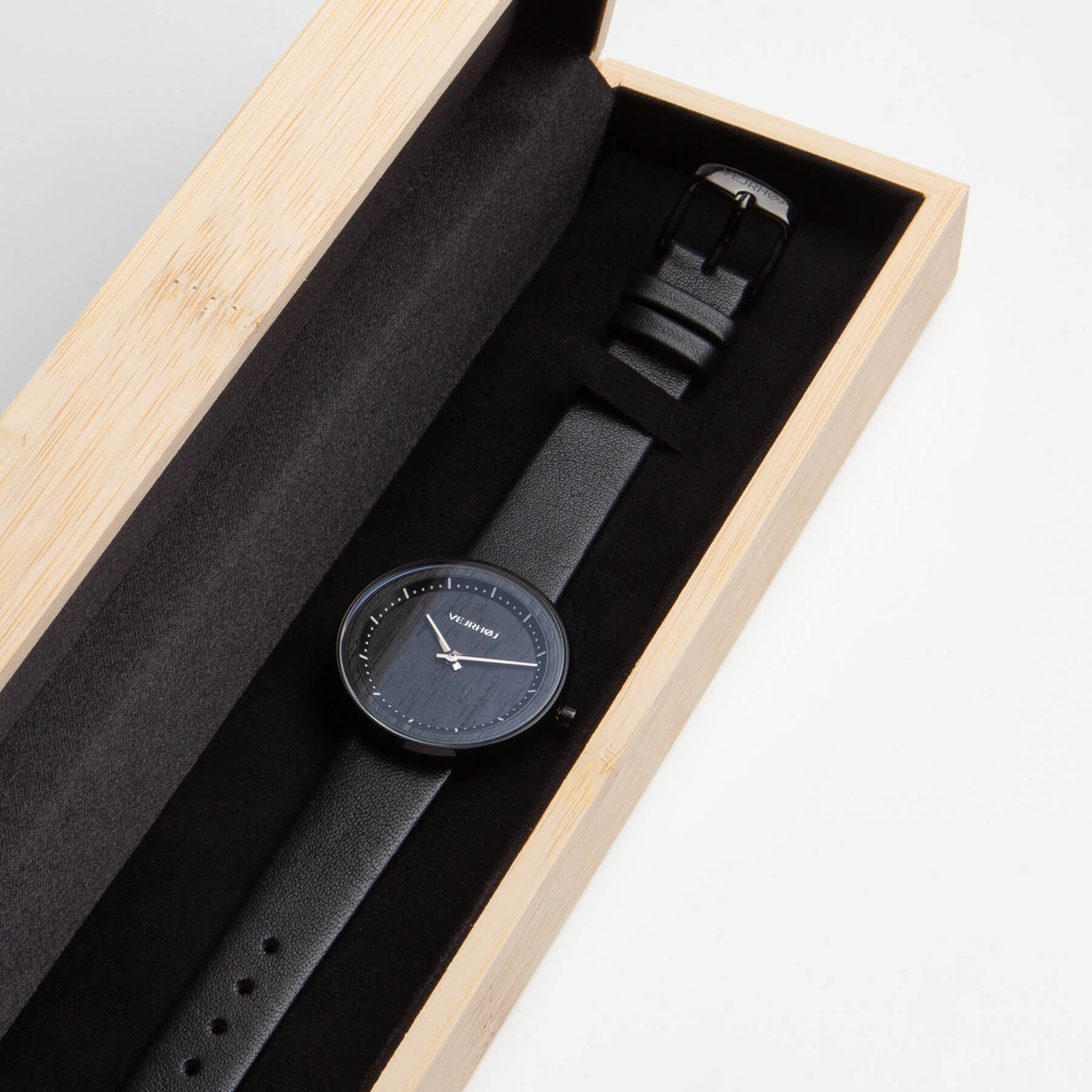Black watch for women with white hour markings in a wooden box