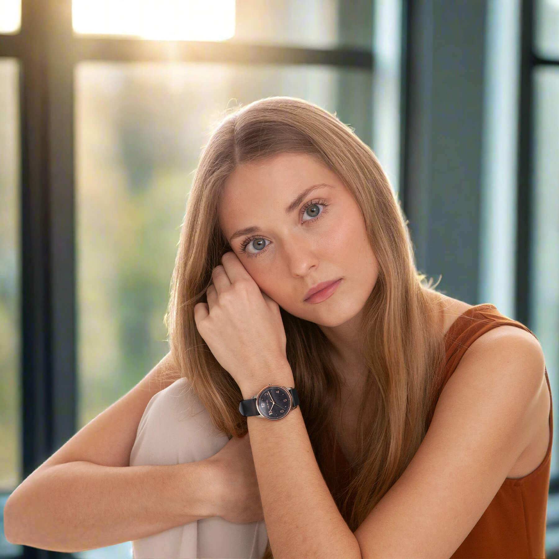 Vejrhøj | Petite Royal black rose being worn by a woman with long reddish hair sitting indoors with a blurred background.