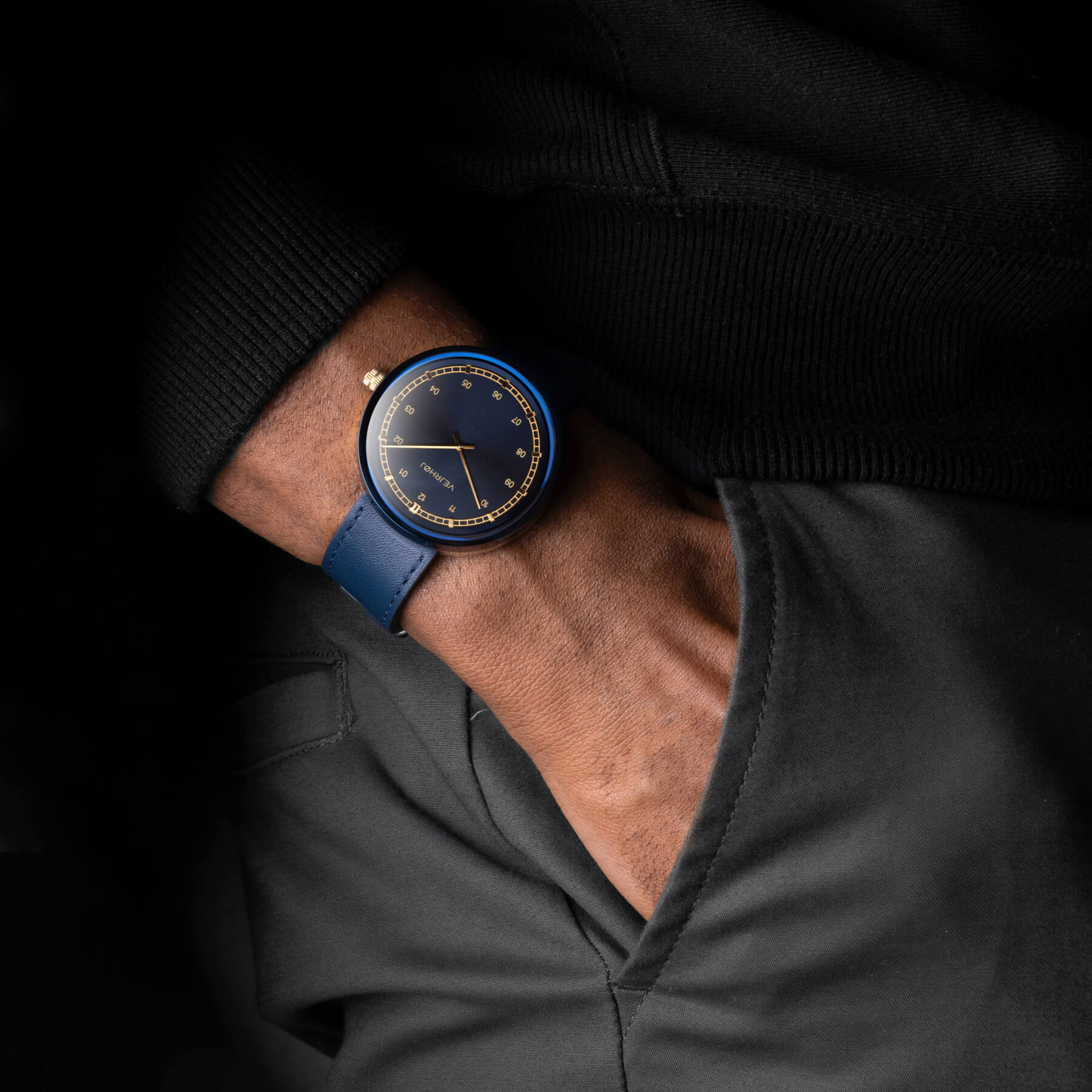 man wearing VEJRHØJ's ARCH Royal blue watch with hands in his pocket 