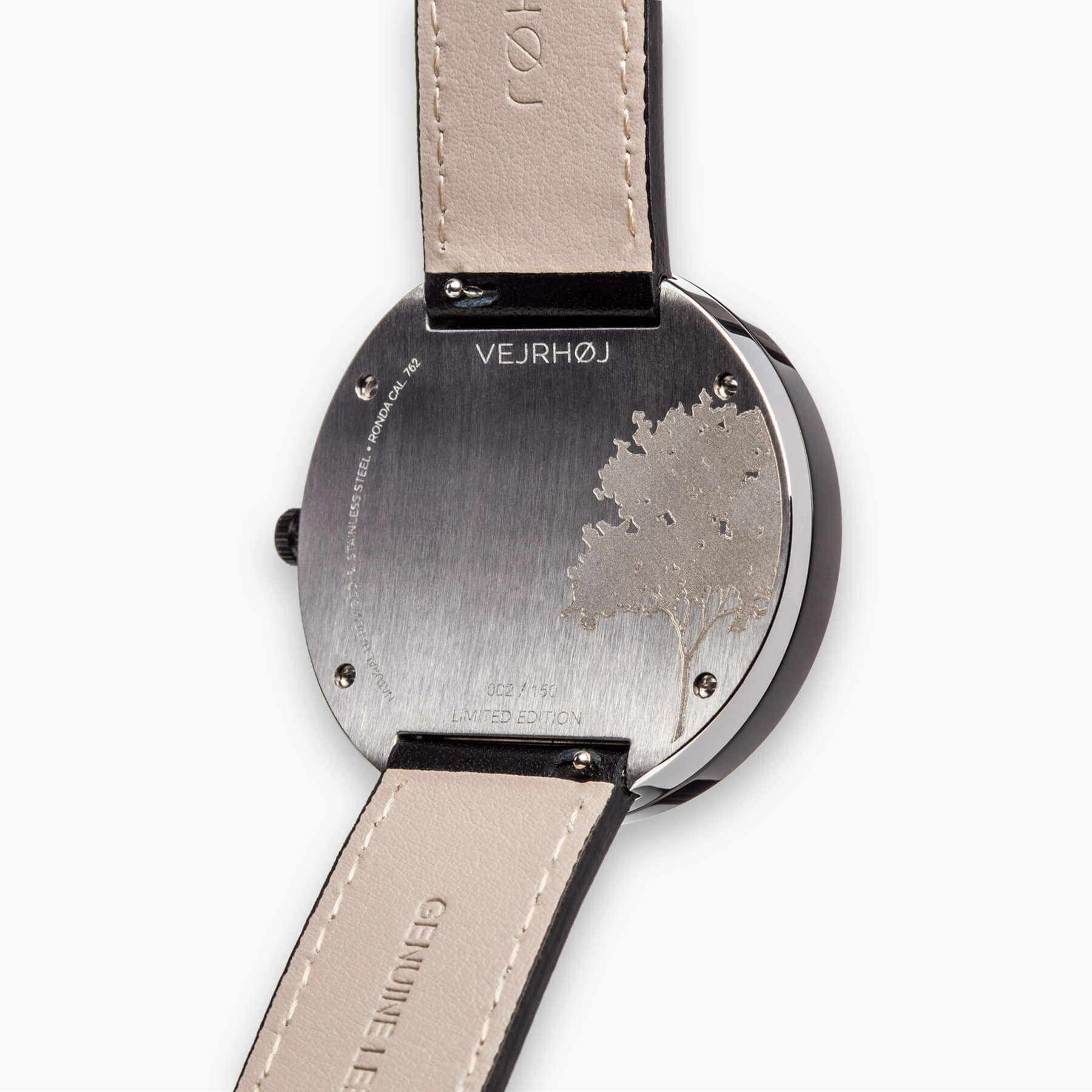 silver watch caseback with VEJRHØJ logo, serial number and tree engraving  
