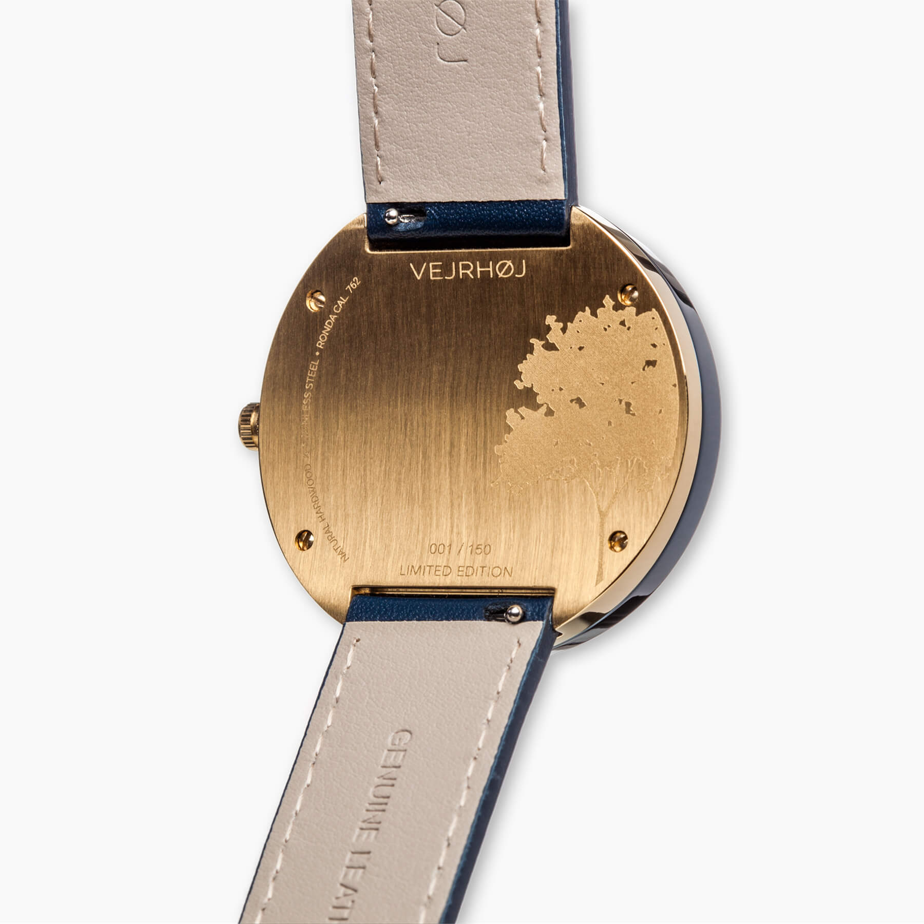 gold watch caseback with VEJRHØJ logo, serial number and tree engraving
