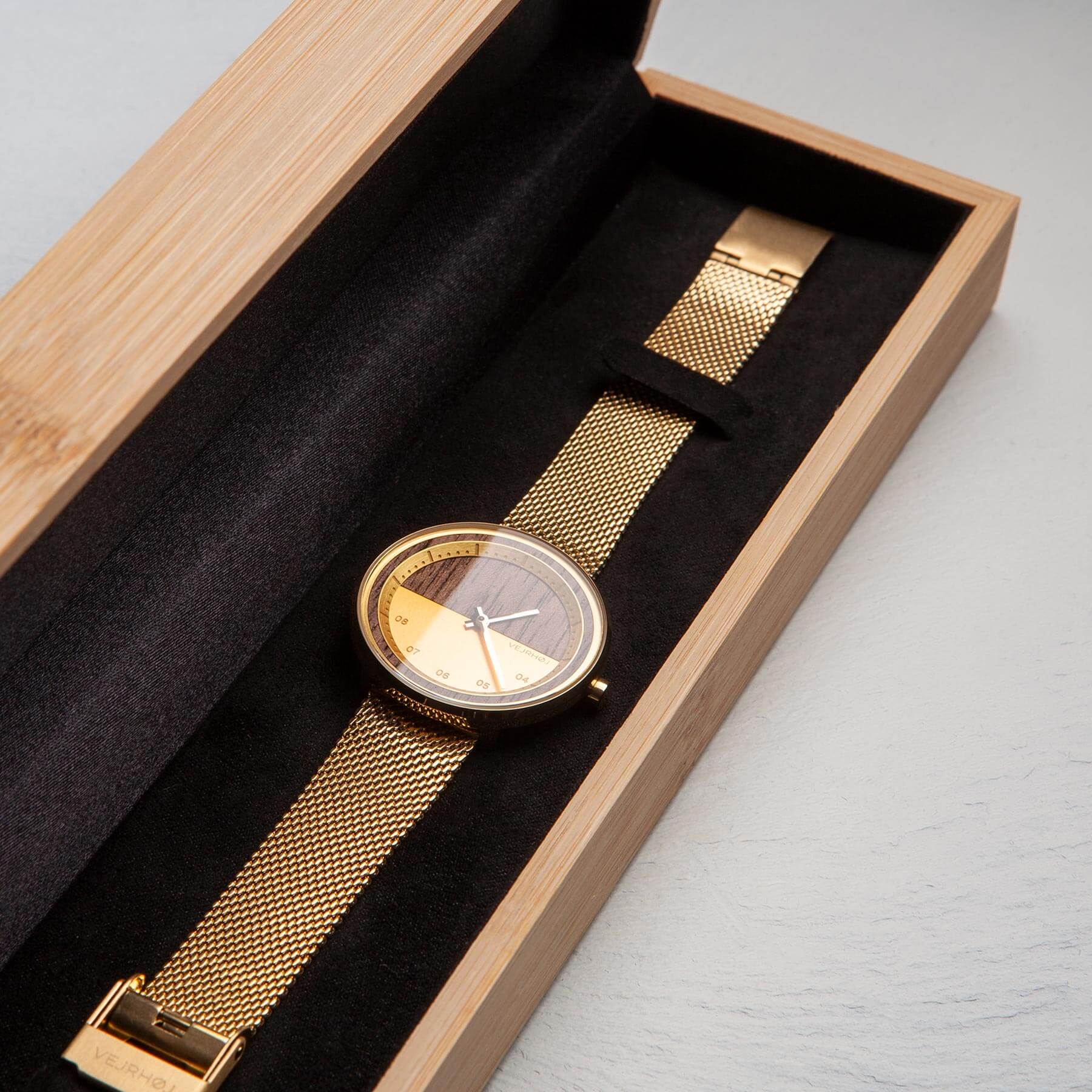 wood watch with golden finish in a wooden box