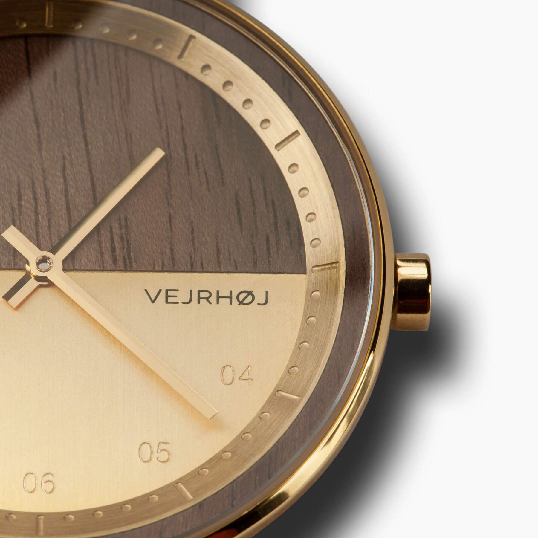 Closeup of petite Gold and wooden watch with golden hands 